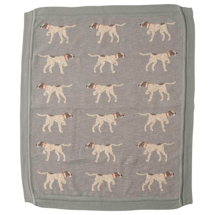 a blanket with dogs on it is shown in grey and brown colors, including the dog's head