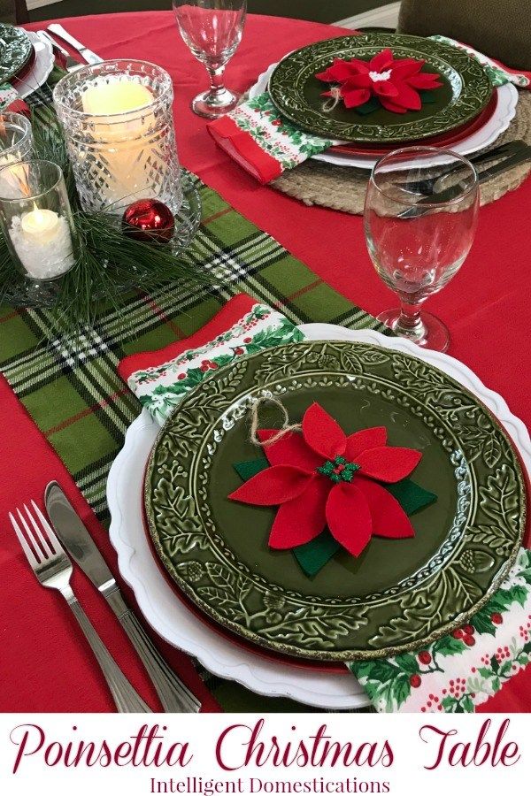 a christmas table setting with poinsettia decorations