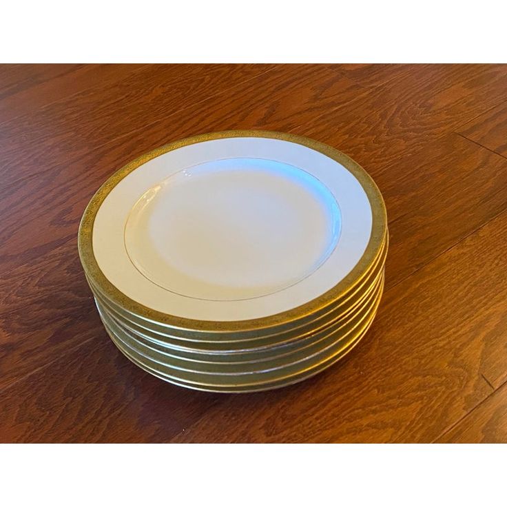 a stack of plates sitting on top of a wooden table