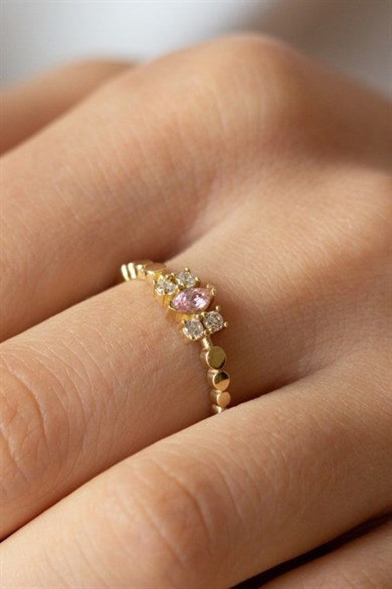 14K Gold  Pink Stone 14K Gold Ring This product is specially prepared for you in the best gold workshops of the Grand Bazaar.  Material: 14K Gold Anti-allergic, Nickel and Cadmium free. 💛 Handcrafted 14K Gold Jewellery 🚚 Worldwide Shipping 🎁 Each of our packages is specially prepared for you as a gift package.   🌸Frequently Asked Questions  When are our products shipped? Your packages are delivered within 24 hours after your payment is received. When will the package arrive? Delivery time va Delicate 14k Gold Pink Ring, Delicate Pink 14k Gold Rings, Dainty 14k Gold Pink Ring, Dainty 14k Gold Cluster Ring With Halo Setting, Dainty Pink 14k Gold Ring, 14k Gold Crystal Halo Ring For Promise, Pink 14k Gold Halo Ring, Delicate 14k Gold Cluster Ring For Promise, Delicate 14k Gold Cluster Promise Ring