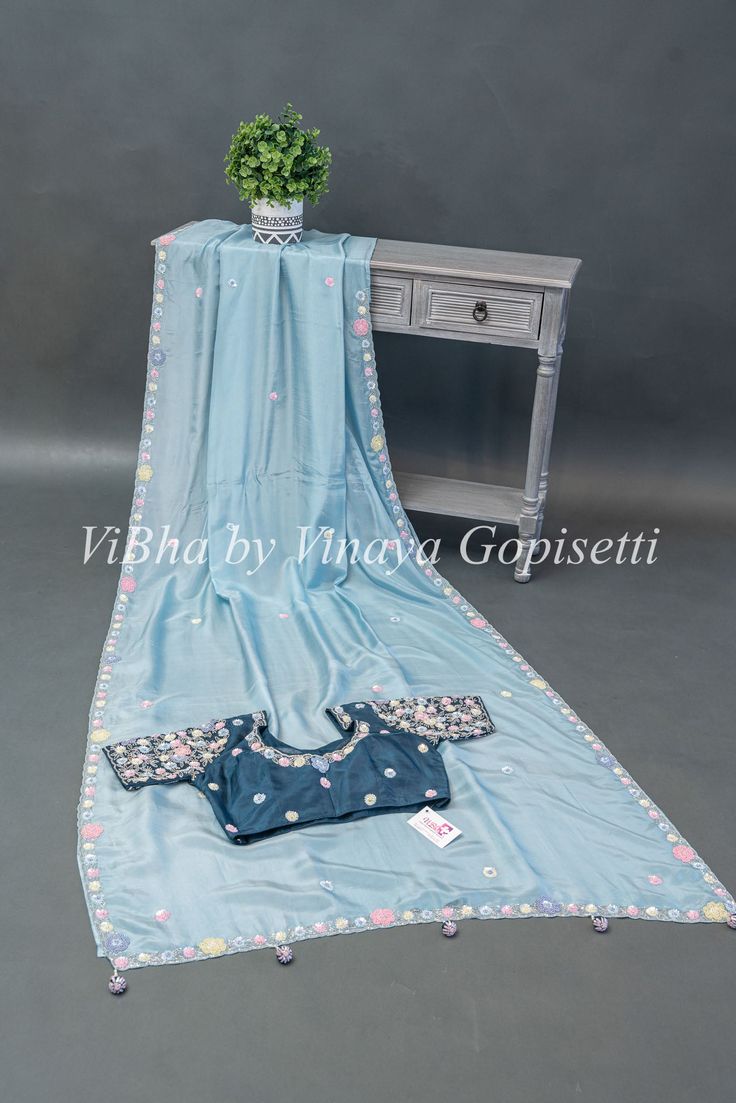 Elevate your style with our Powder Blue and Dark Teal Soft Organza Embroidered Saree And Blouse. This exquisite party wear piece features multi color embroidery, perfect for making a statement at any occasion. Made from lightweight and breathable organza fabric, this saree and blouse combo offers both comfort and elegance. Blue Organza Saree For Diwali, Blue Organza Saree With Cutdana, Pastel Blue Organza Saree, Teal Color Saree, Semi-stitched Blue Embroidered Saree Fabric, Saree And Blouse, Color Embroidery, Embroidered Saree, Elegant Saree