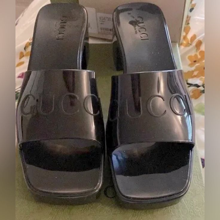 Elevate Your Casual Outfit With These Stylish Gucci Black Rubber Slide Sandals. Perfect For Any Occasion, The Mid-Height Block Heel Provides Comfortable Wear Throughout The Day. The Solid Pattern And Slip-On Closure Are Accented With The Iconic Gucci Logo For A Fashionable Touch. These Sandals Are Perfect For The Modern Woman On-The-Go, And Are Available In Women's Size European Size 38 Us Size 7. Gucci Flat Sandals For Formal Occasions, Designer Black Sandals With Padded Heel, Modern Gucci Sandals For Evening, Designer Patent Leather Sandals With Block Heel, Gucci Formal Flat Sandals, Designer Black Heels For Summer, Designer Patent Leather Block Heel Sandals, Designer Patent Leather Sandals With Flat Heel, Modern Gucci Sandals For Summer