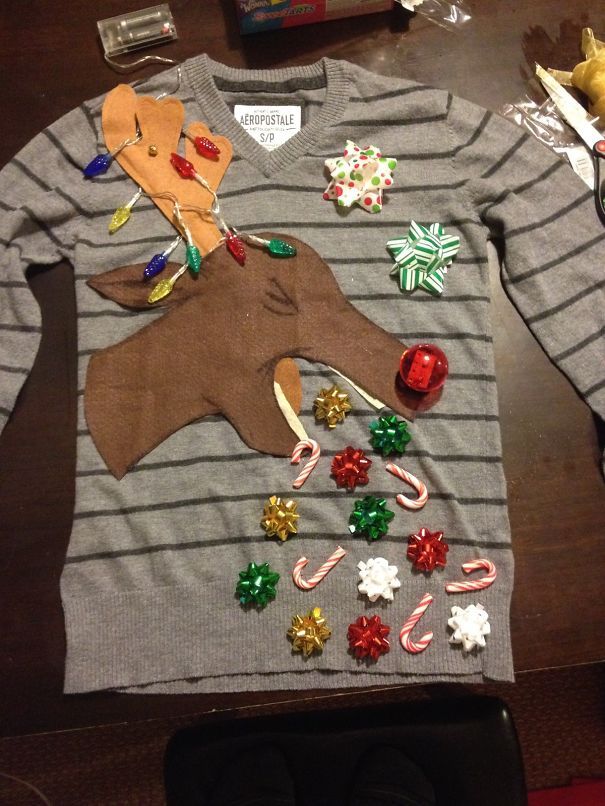 a christmas sweater with an ugly moose on it and candy canes around the neck