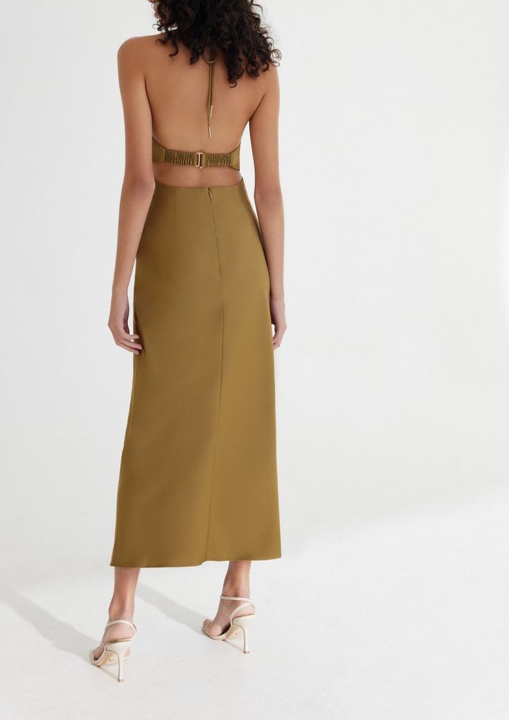 Designed by Significant Other. Crafted with the event season in mind, the Alix Dress in Olive is designed to be fitted through the bodice and drape elegantly toward the hem. Halter neckline with front cut out detail, gathered fabrication at the waist with luxe gold hardware polishing off this elegant silhouette. Fit: Model is 180cm / 5′10″ wearing an AU 8 / US 4 Materials + Care: 62% Viscose Rayon, 38% Polyester. This fabric has been specially woven. Because of its delicate design and characteri Chic Ruched Dress With Cut-out Waist, Elegant Spring Maxi Dress With Cut-out Waist, Chic Midi Dress With Cut-out Waist For Date Night, Elegant Spring Midi Dress With Cut-out Waist, Elegant Midi Dress With Cut-out Waist For Spring, Elegant Midi Dress With Cut-out Waist For Date Night, Cutout Waist Midi Dress For Date Night, Chic Fitted Dress With Cut-out Waist, Elegant Summer Midi Dress With Cut-out Waist