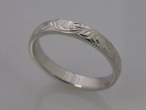 This is my Vine and Leaf Hand Engraved Wedding Band in Palladium white gold, it is a wonderful alternative to the standard 14k white gold which has nickel in it and causes an adverse reaction for some people and is referred to as nickel itch. Band shown in a size 7. Add $50 per size over a size 7. Vine Leaf copyright 2009 White Gold Polished Wide Band Wedding Ring, White Gold Wide Band With Polished Finish For Wedding, Engraved Wide Band Ring With Polished Finish For Weddings, Elegant Etched Engraved Ring For Promise, White Gold Jewelry With Engraving Option For Wedding, White Gold Wedding Jewelry With Engraving Option, Formal Etched Round Band Jewelry, Silver Elegant Wedding Band, Formal White Gold Wide Band For Wedding