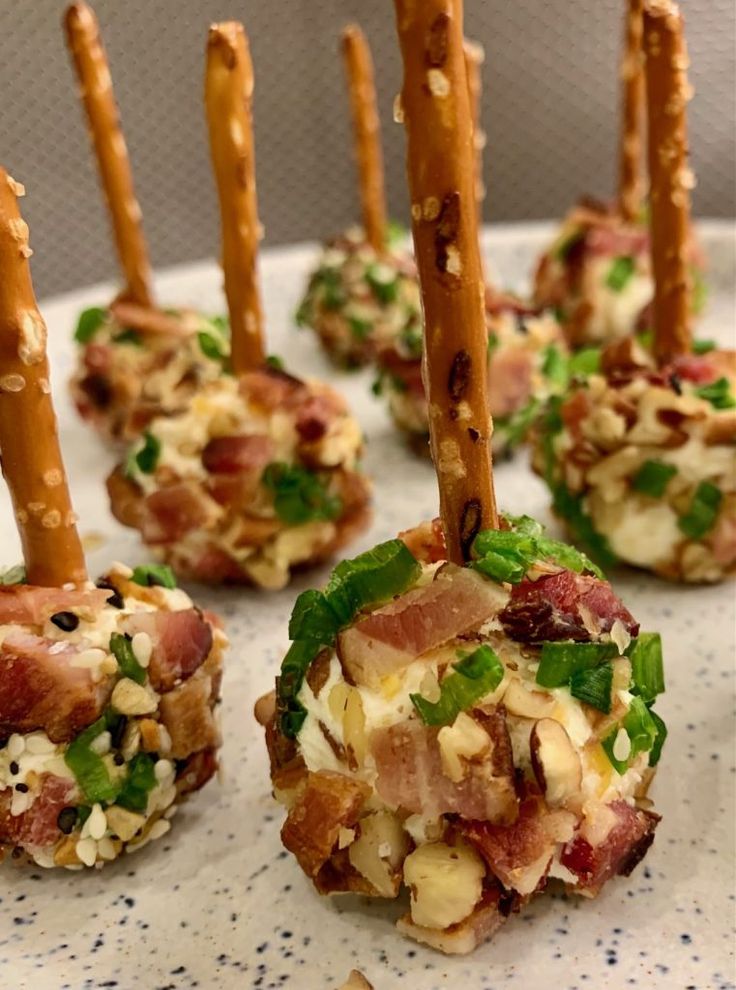 small appetizers are arranged on a plate with toothpicks sticking out of them