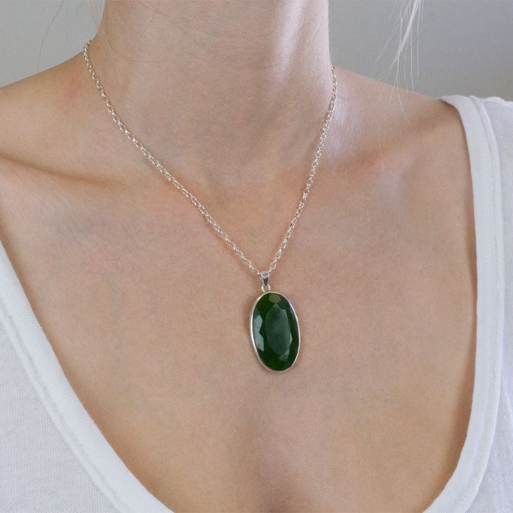 The darker greens in this Nephrite Jade necklace give you more freedom to express yourself. It's a simple neutral gemstone necklace that will brighten your day when paired with other gems. It's all about harmonizing energy with this old, precious crystal necklace. Stone Origin: New Zealand Measures Approximately: 35 x 22 mm Materials: Hand Crafted 925 Polished Sterling Silver and adjustable Italian Belcher chain Please Note: If you would like to purchase a different chain please purchase pendant only and click here. All pieces shipped within 48 hours from our Del Mar Gallery. Jade Oval Pendant Necklace With Natural Stones, Jade Necklace With Oval Pendant And Natural Stones, Green Gemstone Crystal Necklace With Round Pendant, Green Necklace With Oval Pendant And Natural Stones, Green Oval Pendant Necklace With Natural Stones, Green Oval Pendant Necklace For Spiritual Style, Green Oval Pendant Necklace Spiritual Style, Spiritual Green Oval Pendant Necklace, Green Oval Necklace With Large Stone