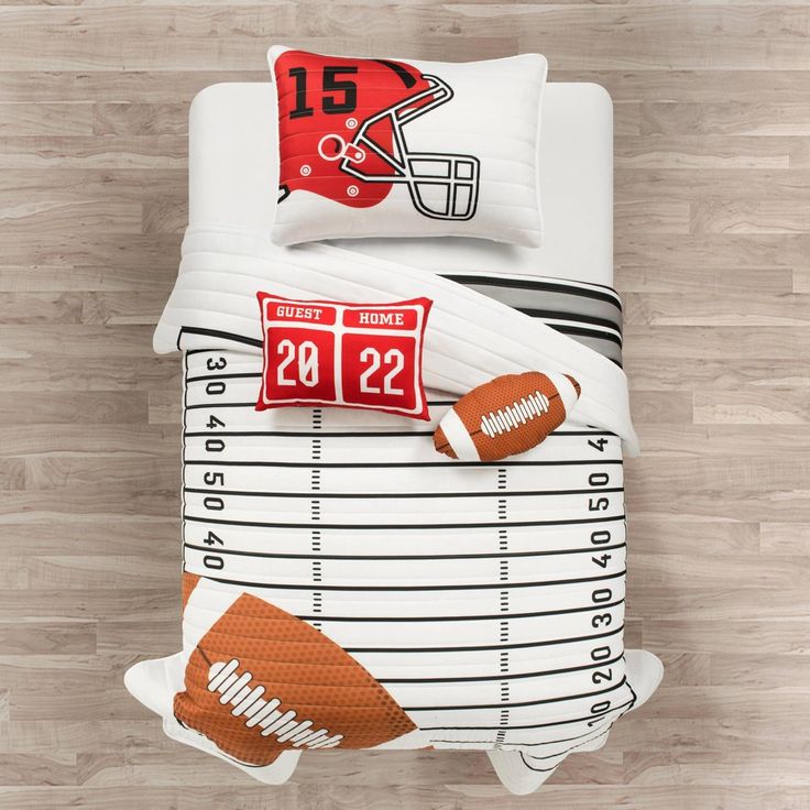 a football themed comforter set on a wood floor