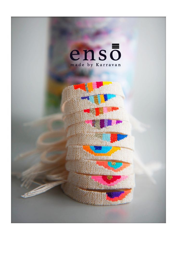 a stack of bracelets sitting on top of a table next to a canister