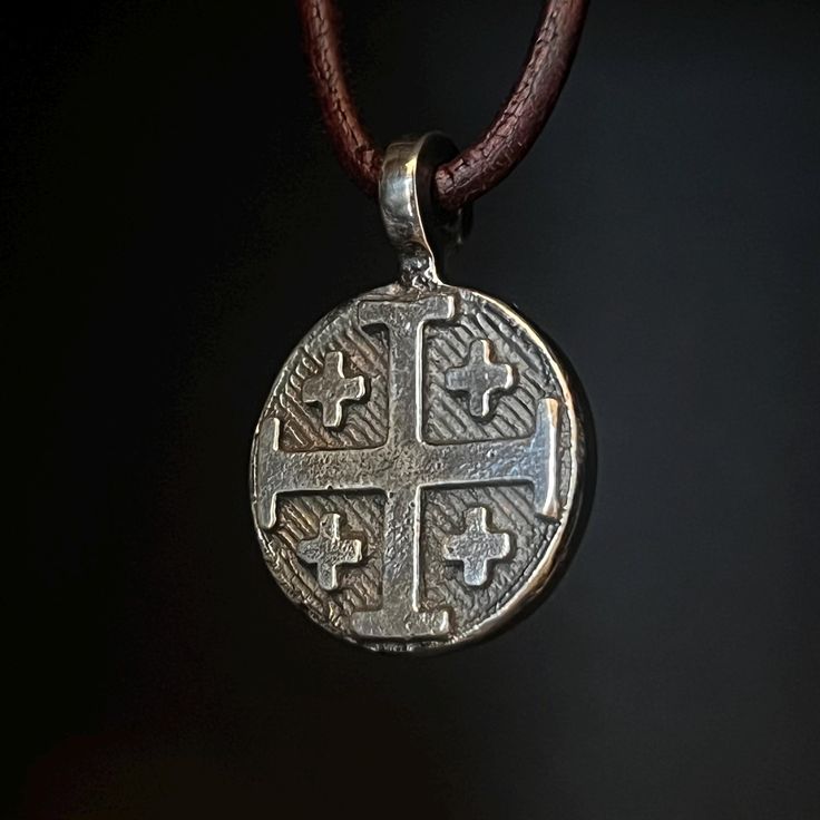 Made to Order, current wait time is 2-3 weeks.  As the owner and artisan behind Valkyrie Steel in Bigfork, Montana, I take great pride in transforming raw materials into meaningful, handcrafted pieces. This Jerusalem Cross pendant is crafted from fine silver, beginning its journey with a reverence for tradition and faith. The Jerusalem Cross, symbolizing the spread of Christianity to the four corners of the earth, is a powerful and timeless design. To create this pendant, I melt fine silver until it reaches a molten state, glowing with an intensity that reflects its transformation. The molten silver is then carefully poured into a custom mold, capturing the intricate lines and symmetry of the Jerusalem Cross. As the silver cools, the pendant takes its shape, unique in texture and finish, a Medieval Engraved Jewelry For Anniversary, Medieval Hand Forged Sterling Silver Jewelry, Medieval Style Adjustable Engraved Jewelry, Silver Hand Forged Medallion Jewelry, Symbolic Round Hand Forged Jewelry, Antique Silver Handmade Artisan Jewelry, Handmade Artisan Antique Silver Jewelry, Artisan Handmade Antique Silver Jewelry, Handmade Artisan Jewelry In Antique Silver