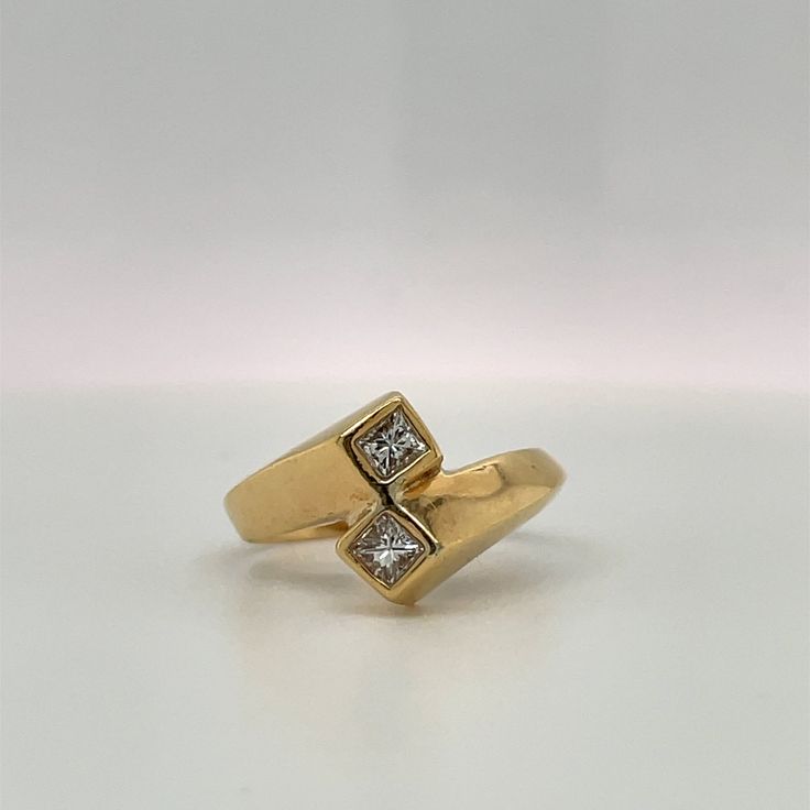 This ring is a simple Retro Design to symbolize Love & Friendship. Would make a great Engagement ring for the bride who does not prefer traditional single center stone ring. Details: Size: The ring is a Size 6. ( can be sized upon request) The stones are: 2 Princess cut Diamonds, Bezel set, G color VS2 clarity. .33ct total. Metal: 14K yellow gold The band tappers from 3.47 to 5.17mm. Every Antique piece of jewelry we sell at Heirloom Pavé has been checked for safety of each prong and repaire Fine Jewelry Bypass Ring With Tension Setting For Promise, Modern Diamond White Bypass Ring For Anniversary, Anniversary Bypass Ring With Single Diamond In White Gold, White Gold Bypass Ring With Single Diamond For Anniversary, Classic Wedding Ring With Bezel Setting, Anniversary White Gold Bypass Ring With Single Diamond, Classic Wedding Ring With Tension Setting And Princess Cut, Elegant Anniversary Toe Rings, Modern Single Diamond Wedding Ring