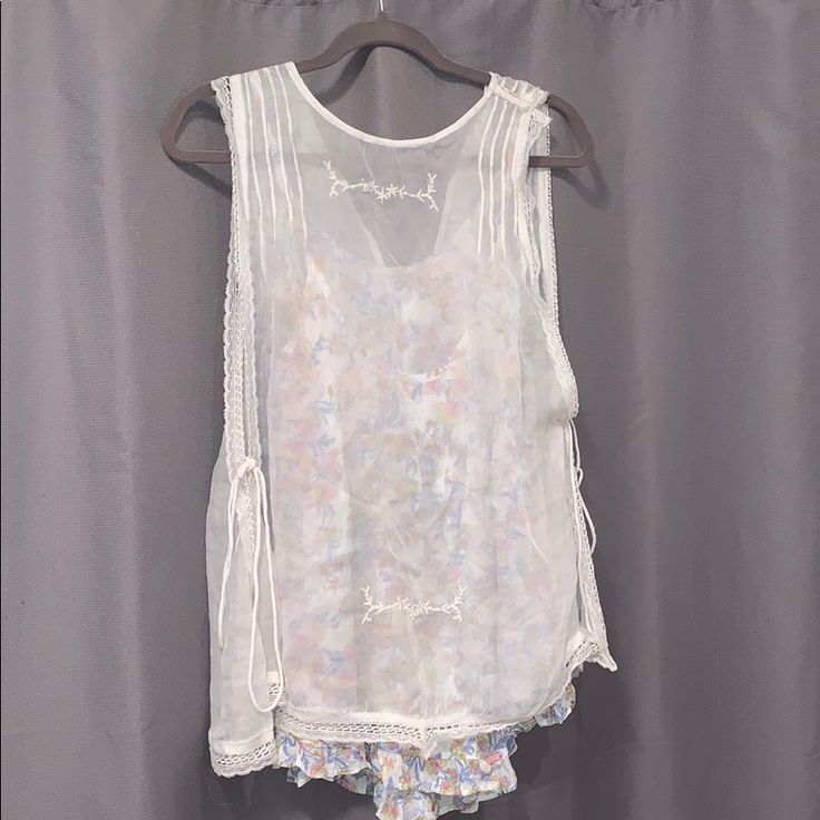 Free People Fancy Tank Top Blouse. Floral Shirt Underneath A Sheer Top. The Sides Tie And Are Flown With Openings. Never Worn Before. Size Xs. Summer Tops With Lace Trim For Daywear, Summer Lace Trim Tops For Daywear, Summer Floral Print Blouse For Loungewear, Floral Print Summer Blouse For Loungewear, Feminine Sheer Tops For Daywear, Summer Blouse With Lace Trim For Daywear, Summer Lace Trim Loungewear Top, Sheer Sleeveless Blouse For Spring, Summer Lace Trim Top For Loungewear