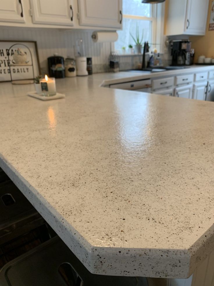 a counter top in a kitchen with white cabinets