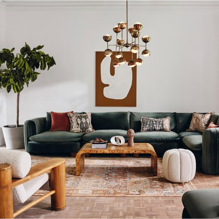 a living room filled with furniture and a chandelier hanging above the couches