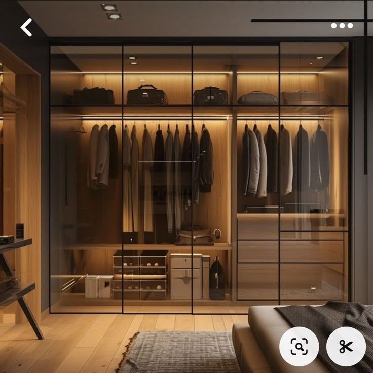 an image of a walk in closet with clothes on hangers and lights above it