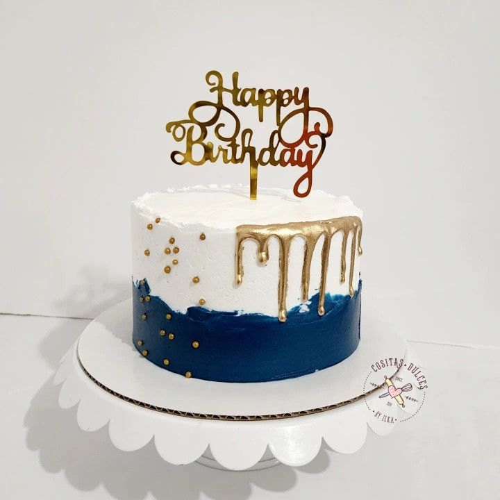 a blue and white birthday cake with gold drips