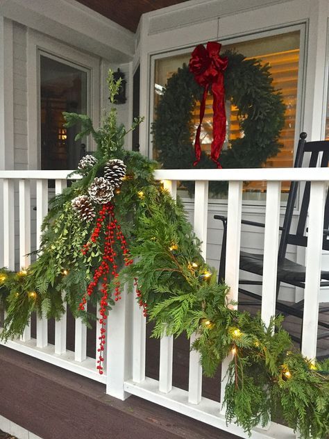 a porch decorated for christmas with wreaths and lights