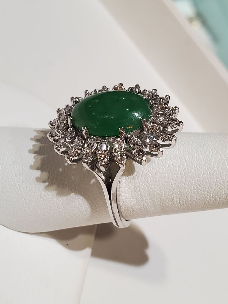 "Platinum Natural Green oval Cabochon Jade And Diamond Ring . The ring measures approx 12.79 grams. The ring size is approx. 6 1/2 can size up or down. The diamond measures .60ctw. The jade itself measures approx.10mm x 14mm oval shape. The ring itself measures approx.24mm x21mm oval shape. The ring marked plat. Inside means platinum. If you have any question send me a message... When listing and describing our items we make a conscious effort to over describe all imperfections and blemishes. Th Classic Oval Gemstones With Halo Setting, Luxury Multi-stone Oval Cabochons, Oval Gemstones With Halo Setting For Formal Occasions, Formal Multi-stone Oval Cabochon Gemstones, Oval Green Diamond Gemstones, Exquisite Oval Gemstones For Formal Events, Exquisite Oval Gemstones For Formal Occasions, Classic Oval Multi-stone Cluster Ring, Luxury Oval Gemstone Cabochons