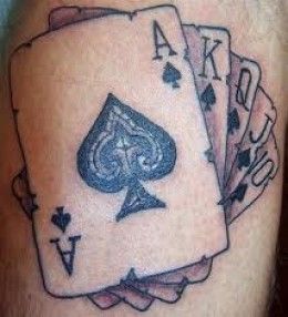 four playing cards tattoo on the arm and leg, with one ace in the middle