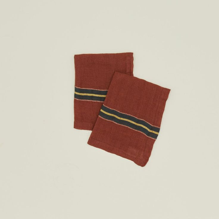 two red and black striped napkins sitting on top of each other