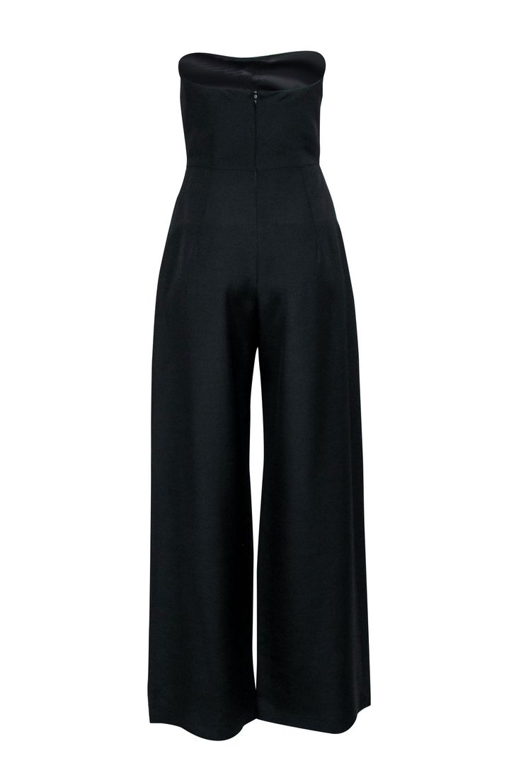 Ditch the dress and sass up your evening with Martin Grant's Black Strapless Jumpsuit. With a chic buckle detail, polished pleats, and wide-leg elegance, this jumpsuit is the perfect pairing for your favorite black pumps. Size S Shell 57% Virgin Wool, 43% Viscose Lining 68% Acetate, 32% Polyester Hidden back zip Buckle detail Strapless Wide-leg Pleated Bust 32" Waist 36" Inseam 32" Length 53" Elegant Strapless Jumpsuit For Spring Cocktail, Elegant Solid Color Pantsuit For Date Night, Sleek Evening Pantsuit For Spring, Formal Strapless Wide-leg Jumpsuit For Spring, Formal Strapless Wide Leg Jumpsuit For Spring, Formal Wide-leg Strapless Jumpsuit For Spring, Formal Full Length Jumpsuits And Rompers, Sleek Black Formal Jumpsuits And Rompers, Elegant Full-length Solid Jumpsuits And Rompers