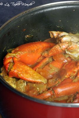 a pot filled with cooked crabs and onions