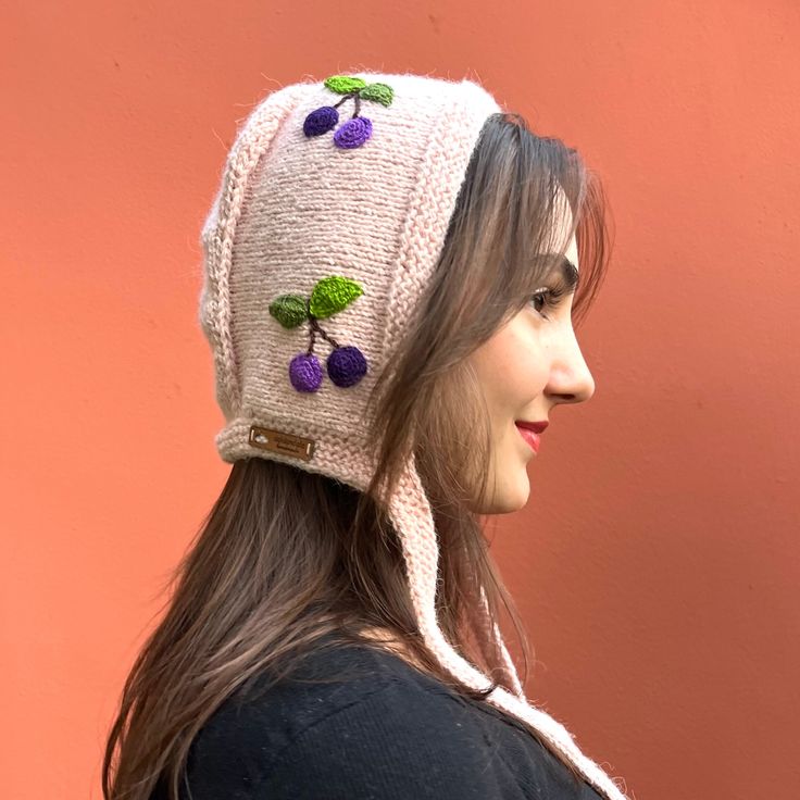 "A unique design for your headwear collection: Hand knitted bonnet with crochet cherry appliqués! 🍒Made from high quality wool&aacrylic mix. 🍒Super warm, cozy and distinctive. 🍒Created and hand knitted by myself. 🍒Available other colors, too. Just check the \"Knit Bonnets\" section.  Care: -Hand wash with cold water." Playful Pink Crochet Hat For Winter, Pink Bonnet For Spring, One Size Fits Most, Spring Pink Bonnet, One Size Fits Most, Adjustable Pink Bonnet As Gift, Cute Handmade Pink Bonnet, Handmade Cute Pink Bonnet, Playful Pink Crochet Hat, One Size Fits Most, Whimsical Pink Crochet Hat For Winter, Cute Pink Crochet Hat For Winter