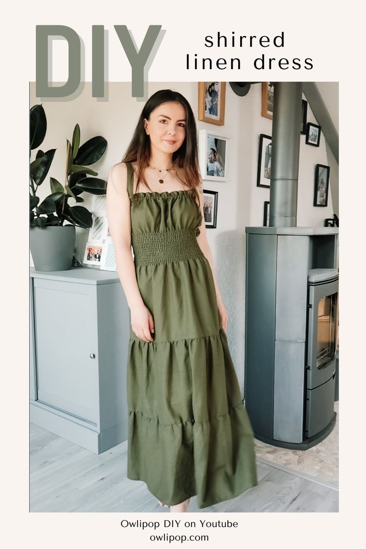 a woman standing in front of a fireplace wearing a dress with tiered hems