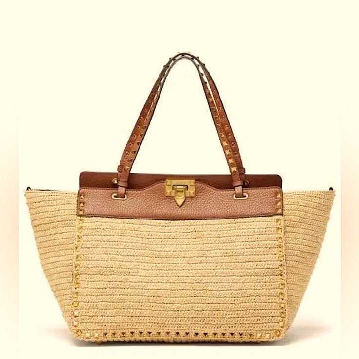 Valentino Garavani "Rockstud Small Raffia And Leather Tote Bag"! Naturale Saddle Brown Calf Skin! Brand New Without Tags! Never Used! Valentino Garavani's Rockstud Small Raffia And Leather Tote Bag In Beige Is Made In The Italian Atelier, With Panels Of Crocheted Raffia Forming The Generous Trapeze Silhouette. It's Left Unlined To Showcase The Faultless Craftsmanship And Structured With Tan Grained Leather At The Topline And Trims, Then Finished By Hand-Applied Gold Rockstuds. Carry It By The Du Luxury Natural Straw Bag With Gold-tone Hardware, Designer Natural Straw Bag With Gold-tone Hardware, Designer Bags With Braided Handles In Natural Color, Luxury Leather Trim Bags For Vacation, Luxury Straw Bags With Gold-tone Hardware, Designer Woven Shoulder Bag For Vacation, Designer Bags With Gold-tone Hardware For Vacation, Luxury Straw Bag With Gold-tone Hardware For Vacation, Designer Straw Bags For Daily Use