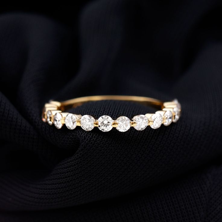 Product Details Elegance and brilliance meet in this stunning Half Eternity Band Ring, adorned with Round Shape Diamond Gemstones meticulously set along the band in a Floating Setting. Each gemstone seems to hover gracefully, forming a captivating and sophisticated design. Product Information SKU SHP-RINGS092021230 Width 2.5 mm Height 2.5 mm Weight 1.84 gm (Approximate) DIAMOND INFORMATION No.of Stones 15 Pieces Total Weight 1.35 Carat (Approximate) Dimension(approx) Round-2.40X2.40 mm-15 Pcs Co Half Eternity Band, Eternity Band Ring, 18k Yellow Gold Ring, Diamond Rings Bands, Sophisticated Design, Eternity Band, Design Product, Quality Diamonds, Eternity Bands