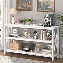 a white shelf with books and other items on top of it in a living room