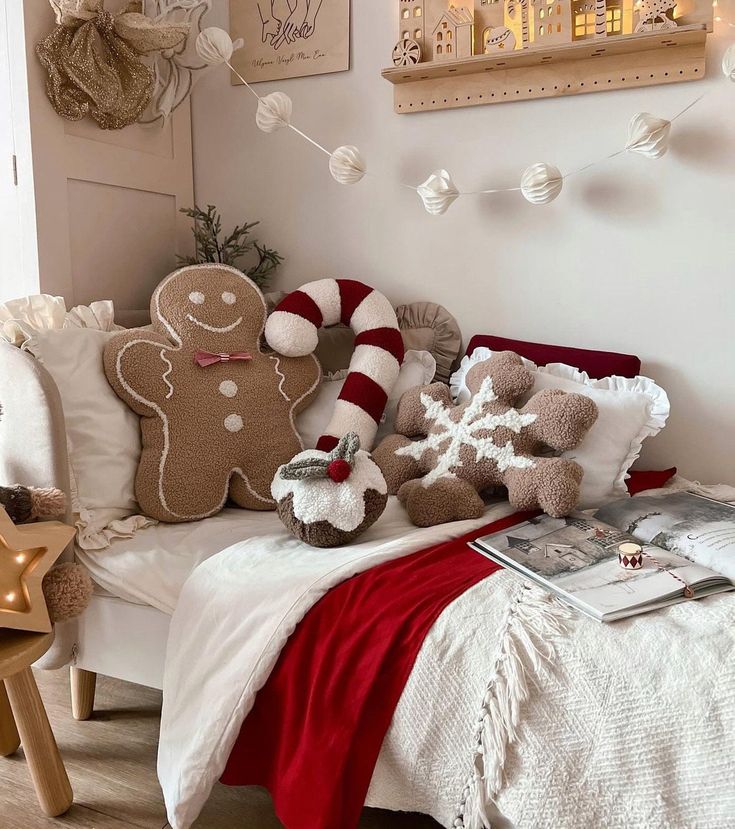 a bed with christmas decorations on the headboard and pillows in front of it, along with two teddy bears