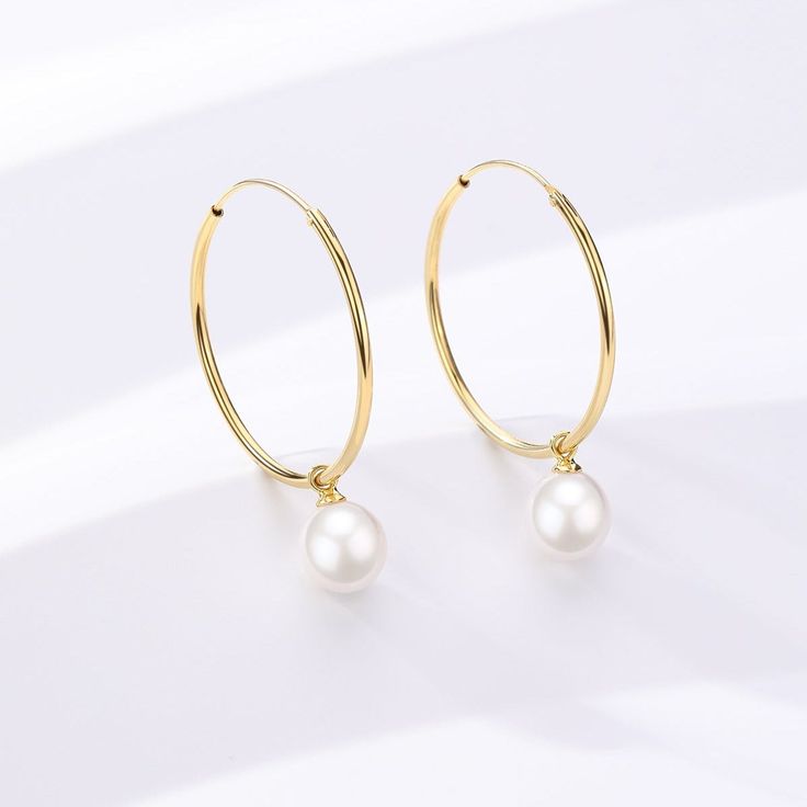 Unveil your elegance with our Freshwater Pearl Drop Large Hoop Earrings. Carefully constructed gold vermemil on Sterling Silver, these hoops offer a harmonious blend of contemporary grace and timeless appeal. The attached freshwater pearl renders a classic touch, creating a versatile piece that suits both everyday elegance and sophisticated soirées. Immerse yourself in the delicate charm and modern luxury of this exquisite pair. Pearls size: 8-9mm Classic Gold Pearl Huggie Earrings, Dainty Yellow Gold Hoop Earrings With Pearl, Gold-plated Hoop Earrings With Pearl Drop For Anniversary, Gold Plated Hoop Earrings With Pearl Drop For Anniversary, Gold Pearl Hoop Earrings For Anniversary, Elegant Gold Pearl Huggie Earrings, Elegant Gold Huggie Earrings With Pearl Charm, 14k Yellow Gold Filled Round Pearl Earrings, Classic Gold Hoop Earrings With Pearl Charm