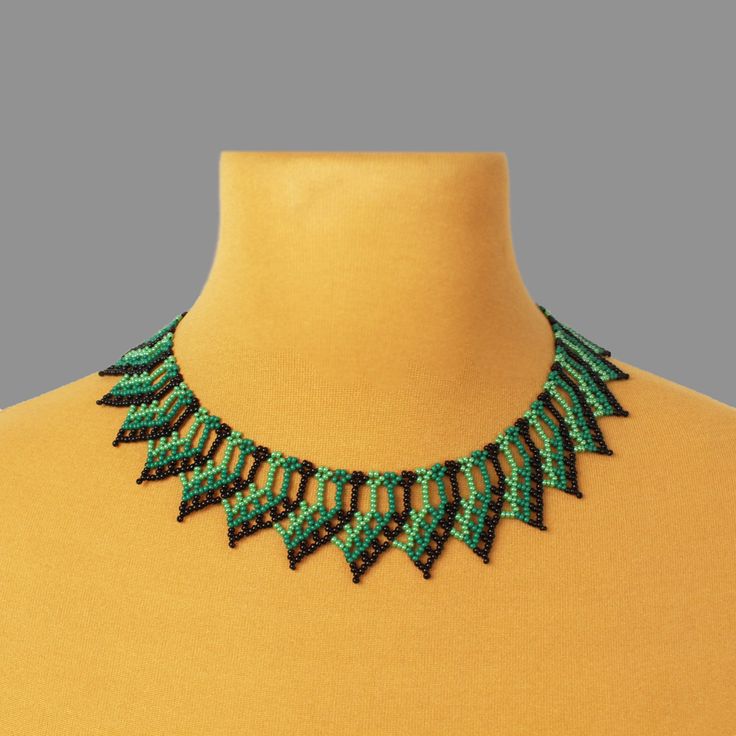 "The green bead necklace adds a unique touch to your overall look, making you stand out from the crowd. Suitable for any occasion, this cute necklace can be paired with both casual and formal outfits, adding a touch of sophistication. Despite its size, this bead collar necklace is lightweight, ensuring comfort throughout the day. ------------ SIZE:  The total length of the necklace is 15.4 inches (39 cm), with a width of 1.4 inches (3.5 cm), and it features an adjustable chain that can extend the collar necklace by an additional 2 inches (5 cm). The lobster claw closure ensures secure and easy fastening. ------------  Materials: Glass beads are used to create this captivating piece of jewelry, guaranteeing durability and a radiant shine. ----------- How to keep your handmade necklace in pe Unique Green Necklaces For Festivals, Unique Green Necklace For Festival, Unique Green Necklace For Festivals, Unique Green Choker For Festival, Unique Green Festival Choker, Green Bohemian Beaded Choker Necklace, Bohemian Green Beaded Choker Necklace, Green Beaded Chain Jewelry, Beaded Emerald Necklace For Gift