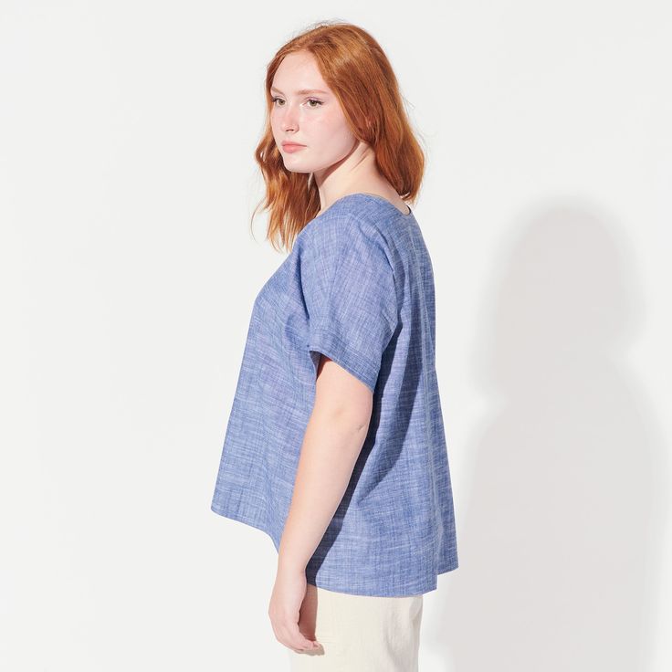 This airy, oversized blouse features two triangle cut-outs at the chest. Made with a lovely light chambray with a bit of stretch (cotton with lycra). Blouse is 23.5" long in front and 27" long in back. Fit is loose. Machine wash and dry.Need a custom length? Just ask!This tee is MADE TO ORDER and ships within TWO WEEKS. SIZE CHART Oversized Summer Tops For Everyday, Oversized Tops For Everyday Summer Wear, Oversized Everyday Summer Tops, Light Indigo Summer Shirt, Relaxed Fit, Breezy Cotton Top For Day Out, Effortless Linen Tops For Day Out, Relaxed Fit Cotton Blouse For Everyday, Cotton Blouse With Relaxed Fit For Everyday, Everyday Relaxed Fit Cotton Blouse