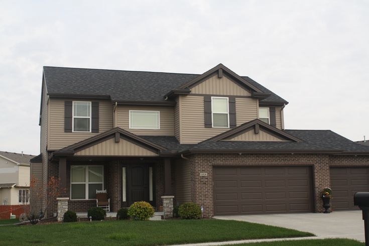 a large house with two garages in the front yard