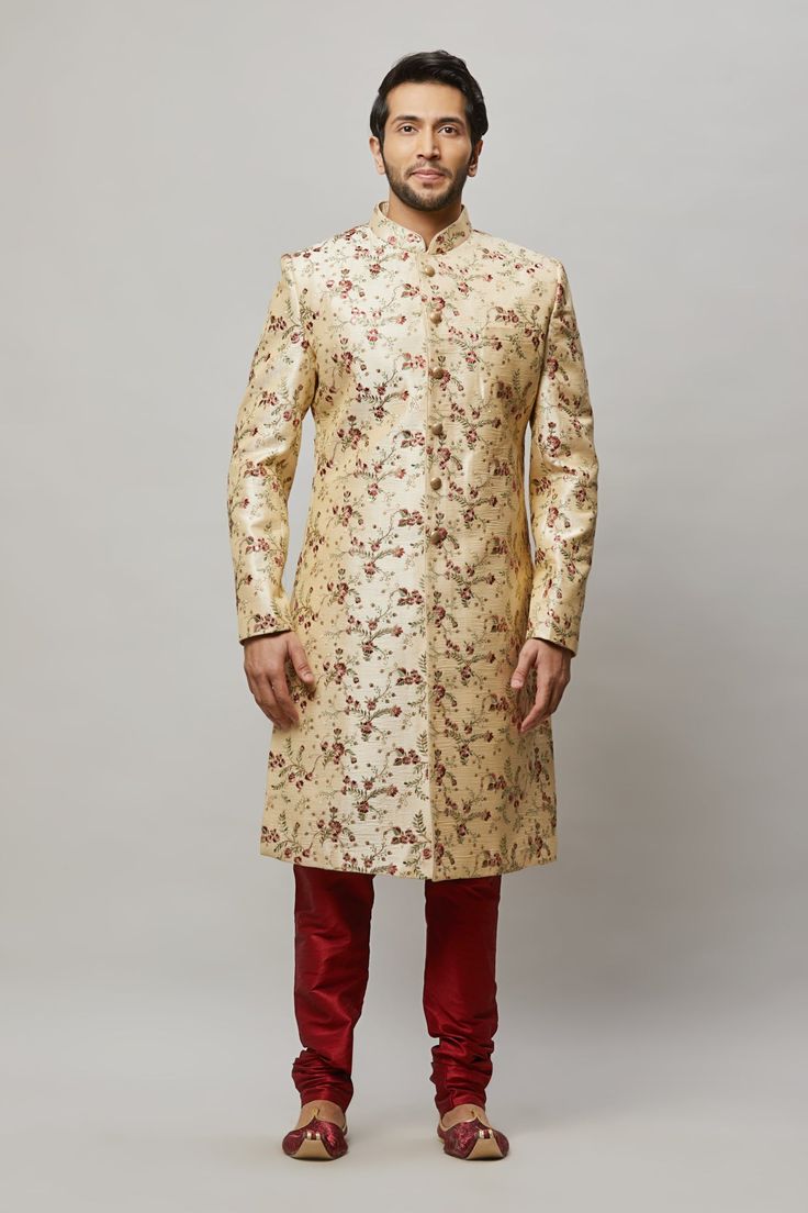 Men's floral embroidered sherwani with shades of Red, Blush & Sage in the flowers and petal Comes with a Red churidar Crafted with a collar neckline, full sleeves, and front button closure. Occasion: Can be worn to events like Sangeet, & Wedding WASH CARE INSTRUCTIONS - Please Dry clean only when it is applicable. Slight color variation is possible due to digital photography. Necklace not included Formal Nehru Jacket With Floral Embroidery And Straight Cut, Formal Nehru Jacket With Floral Embroidery And Straight Fit, Formal Straight Nehru Jacket With Floral Embroidery, Bollywood Style Floral Embroidered Sherwani For Eid, Eid Bollywood Sherwani With Floral Embroidery, Festive Sherwani With Floral Embroidery For Festivals, Designer Floral Embroidered Traditional Sherwani, Elegant Sherwani With Floral Embroidery, Formal Sherwani With Floral Embroidery For Diwali