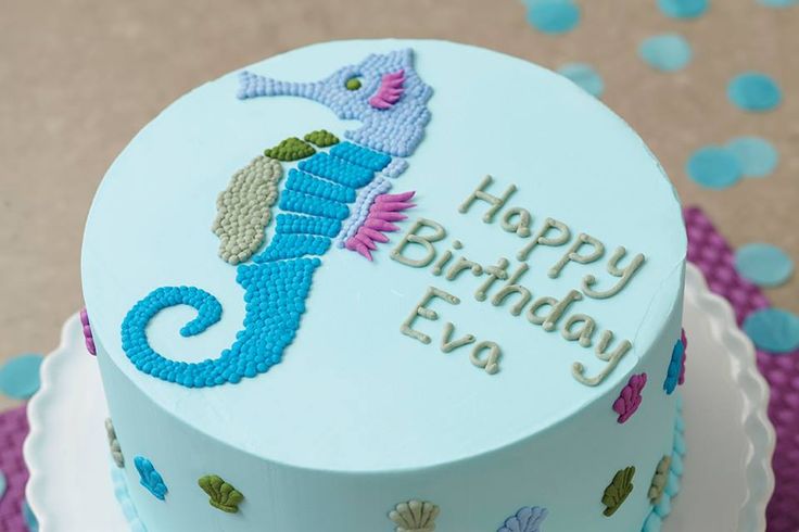 a birthday cake decorated with an image of a sea horse