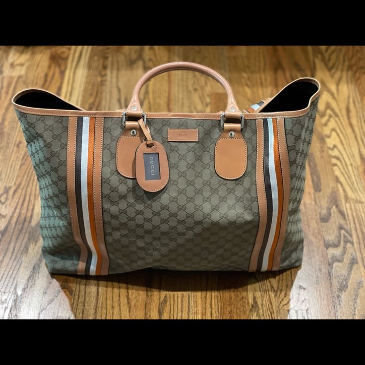 Serious Shoppers Only. Gorgeous And Never Carried Gucci Overnight Travel Bag. Can Be Used As A Large Beach Bag Or Large Travel Tote. This Is From My Personal Collection And I’ve Never Used It So It Is Brand New. No Flaws. Comes From A Non Smoking Home With No Pets/Pests. Comes With Original Cards And Dust Bag. Measures 16*24*5 (Approximately) This Is 100% Authentic. Inside Has A Zipper Pocket. Bag Closes With Clasp Hardware, See Pics. Hardware Is Gold. This Bag Holds A Lot. It’s Big!!! Truly A C Designer Rectangular Coated Canvas Travel Bag, Designer Rectangular Travel Bag For Shopping, Designer Travel Bag With Double Handle For Shopping, Designer Shopping Travel Bag With Double Handle, Designer Double Handle Travel Bag For Shopping, Designer Monogram Canvas Travel Bag For Everyday Use, Monogram Canvas Tote Travel Bag, Luxury Shopping Travel Bag With Handles, Designer Coated Canvas Tote Travel Bag