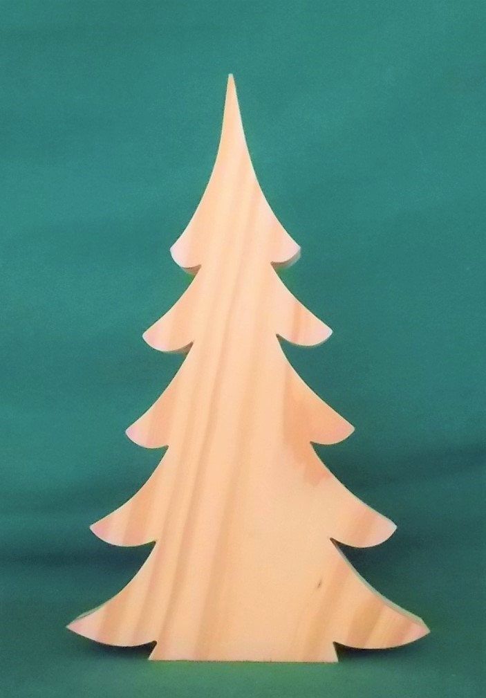 a wooden christmas tree on a green background