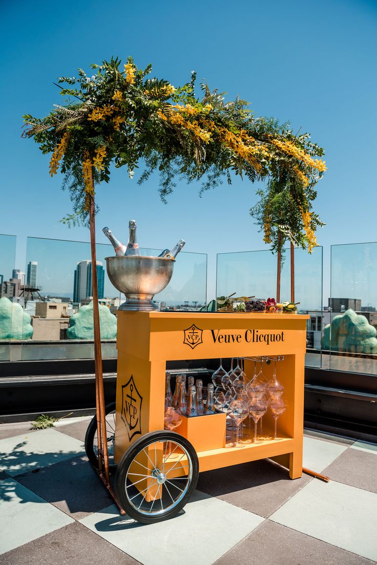 an orange cart on top of a building with a tree in the middle of it