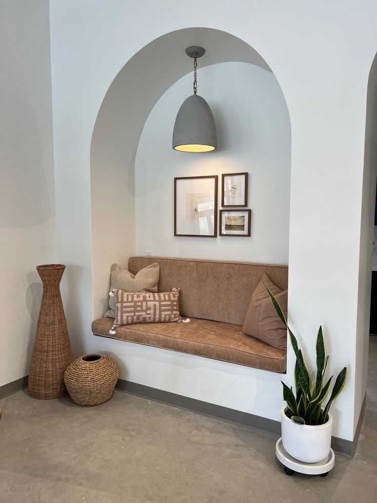 a living room filled with furniture and a potted plant