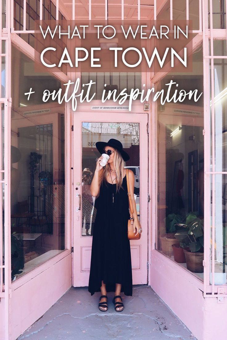 a woman standing in front of a pink building with the words what to wear in cape town