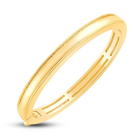 A lustrous high-polish center band is bordered above and below by dynamic milgrain trim in this exciting children's solid bangle bracelet 18K Yellow Gold The 4.0mm bangle bracelet secures with a fancy clasp Classic Bracelets With Decorative Band As Gift, Classic Formal Bracelets With Decorative Band, Classic Bracelets With Decorative Band For Formal Occasions, Classic Gold Jewelry With Fluted Bezel, Yellow Gold Bangle Bracelet With Decorative Band, Yellow Gold Bangle With Decorative Band, Elegant Yellow Gold Bracelet With Decorative Band, Classic Shiny Round Bangle, Classic Shiny Bangle For Anniversary