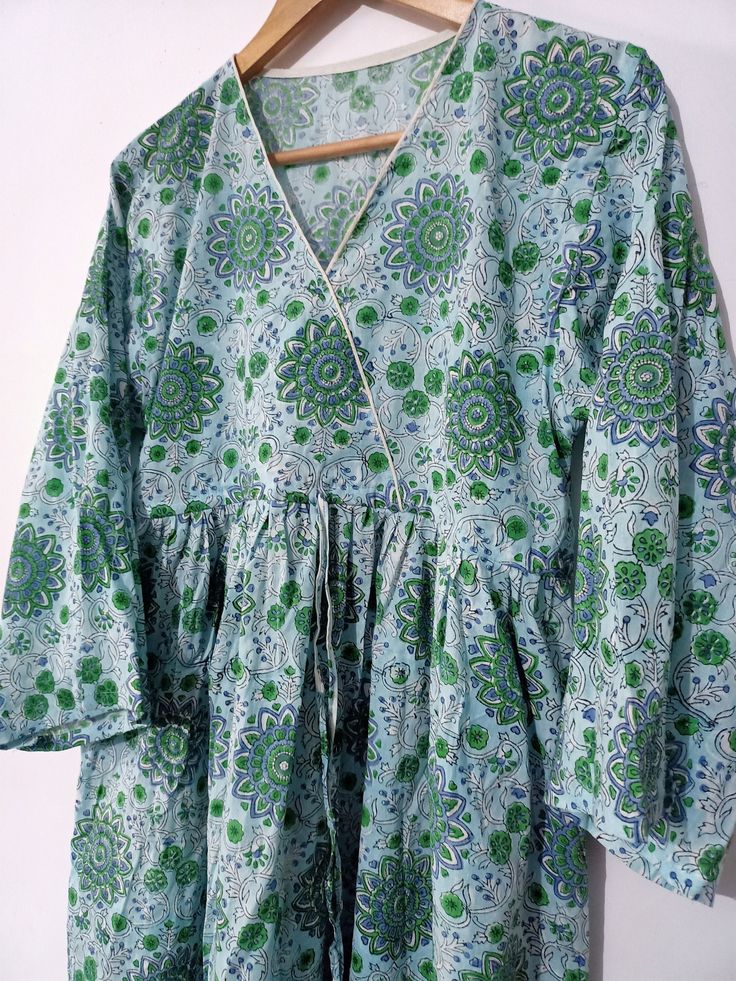 A Indian block print indian cotton dress Cotton, Pure Cotton, Block Print, Hand Made, Hand Block, Wooden Dye, Vegetable Dye, Natural Dye, Long Dress, Easy Wear, Blue Dress, Christmas, Natural Colour Description Hand block printing is an ancient art form that utilizes a hand carved wood block, dipped in dye and stamped by hand onto fabric. Size - bust 40-42 inch Waist-38-40 inch Hips_52 inch Length --50 inch Round-80-100 inch whole Hand wash cold separately. 100% cotton fabric. The model is weari Cotton V-neck Bollywood Kurta, Bollywood Style V-neck Cotton Kurta, Bollywood Style Cotton V-neck Kurta, Cotton V-neck Kurta With Floral Print, Cotton V-neck Kurta For Navratri, Green Bollywood Tunic Dresses, Multicolor Cotton V-neck Kurta, Cotton V-neck Kurta With Printed Motifs, Green Printed V-neck Kurta