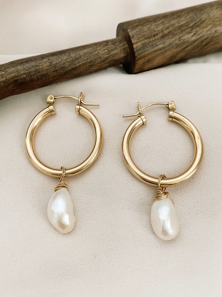 These hoops are another of my favorite earrings in my collection. A classic hoop with a statement Freshwater Pearl. Dress them up or down. Is crafted from 2mm tubing, making it lightweight and comfortable to wear. The hinged post simply clicks securely into the catch to create a fast, easy-to-use closure. These hoops are 14/20 gold filled, rose gold filled and sterling silver. • tarnish resistance• these gold hoops are made with hypoallergenic tubing for sensitive skin. Material 14K gold-filled Gold Brass Hoop Earrings With Pearl Drop, Gold Hoop Earrings With Pearl Drop In Brass, 14k Gold Filled Hoop Earrings With Pearl Drop, 14k Gold-filled Tarnish-resistant Hoop Earrings, Tarnish Resistant 14k Gold Filled Hoop Earrings, 14k Gold Filled Tarnish Resistant Hoop Earrings, Tarnish Resistant 14k Gold Filled Dangle Hoop Earrings, Small Gold-plated Hoop Earrings With Pearl Drop, Nickel Free 14k Gold Filled Hoop Earrings