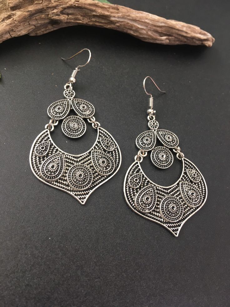 Indus Earrings : Back to our Roots. For the women who makes a statement.  An exclusive shop for earrings. Wear them with pride.  These are dangling drops style earrings . An unique handmade Indian style ethnic bohemian/ Tribal earrings in silver shade.  These earrings are made from high quality Tatanium / German silver material  which are hypoallergenic and free from corrosion & rusting.  Notes : The product shipped will be same as shown in the picture, however the actual colours may vary slightly due to the natural lighting in the photography. We do not accept returns or refunds , however in case of any issues we will definitely try and resolve it. Bohemian Silver Teardrop Earrings, Bohemian Oxidized Teardrop Dangle Earrings, Bohemian Teardrop Oxidized Earrings, Bohemian Silver Oxidized Teardrop Earrings, Bohemian Teardrop Dangle Earrings With Oxidized Finish, Bohemian Metal Plug Earrings With Ear Wire, Bohemian Metal Plug Earrings For Pierced Ears, Bohemian Metal Chandelier Earrings With Ear Wire, Bohemian Teardrop Chandelier Earrings For Pierced Ears