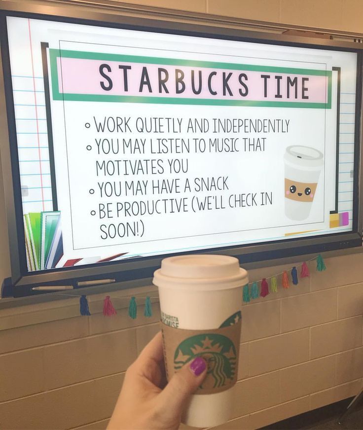 a person holding a starbucks cup in front of a tv with the words starbucks time on it