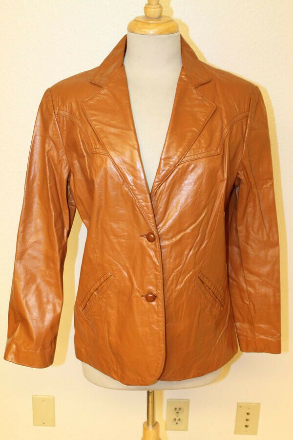 WOMENS SHEPLERS VTG BRONZE BROWN LEATHER BLAZER/JACKET SZ 14 ITEM FEATURES Brand: SHEPLERS VINTAGE BRONZE BROWN LEATHER BLAZER/JACKET  Material           Outside: Leather             Liner: NYLON            Condition         Outside: Very Good. Minor nicks and scuffs.  (see pictures)         Liner: Very Good  (see pictures) Size: 14 (Sizes vary between brands and eras, so please use the measurements below for a better gauge of actual size.) Measurements (measured flat) Chest (armpit to armpit): Spring Formal Brown Blazer, Brown Leather Single-breasted Blazer, Classic Brown Blazer For Spring, Classic Brown Spring Blazer, Formal Brown Single-breasted Leather Jacket, Vintage Leather Fitted Blazer, Vintage Fitted Leather Jacket For Formal Occasions, Brown Leather Jacket With Notch Lapel For Spring, Classic Brown Leather Jacket For Formal Occasions