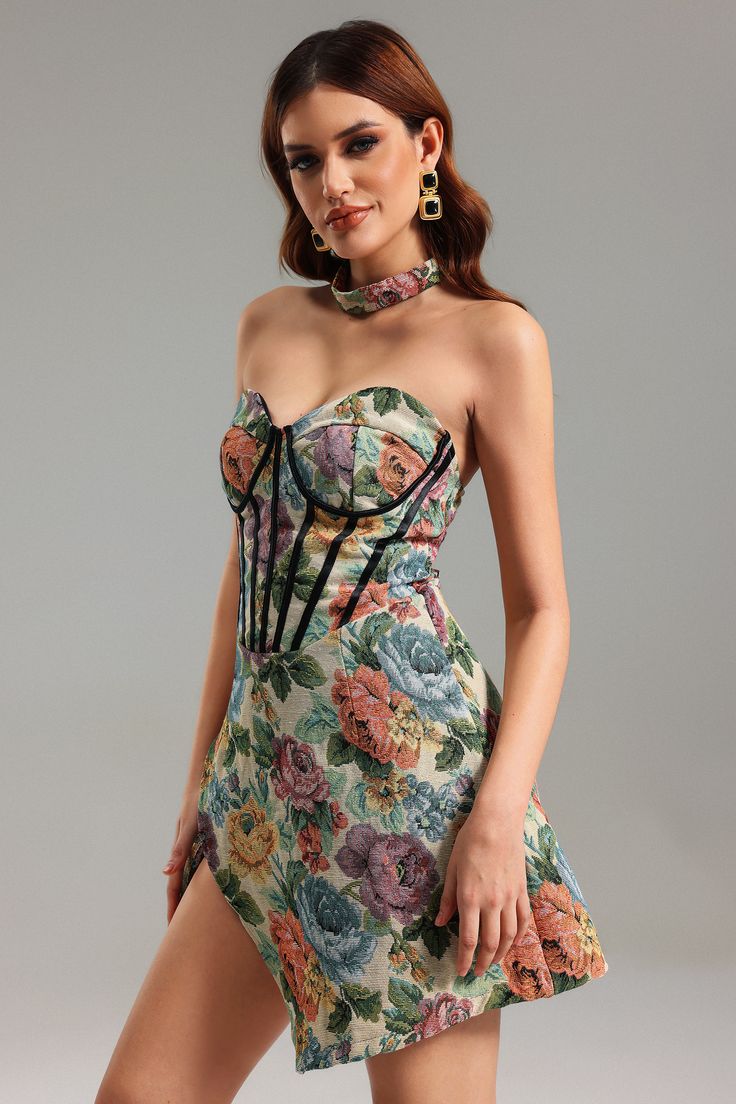 a woman in a floral dress posing for the camera